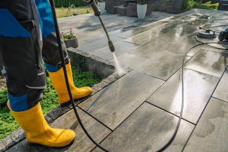 Professional pressure washing cleaning a stone patio and driveway in Suffolk, transforming outdoor spaces with professional equipment