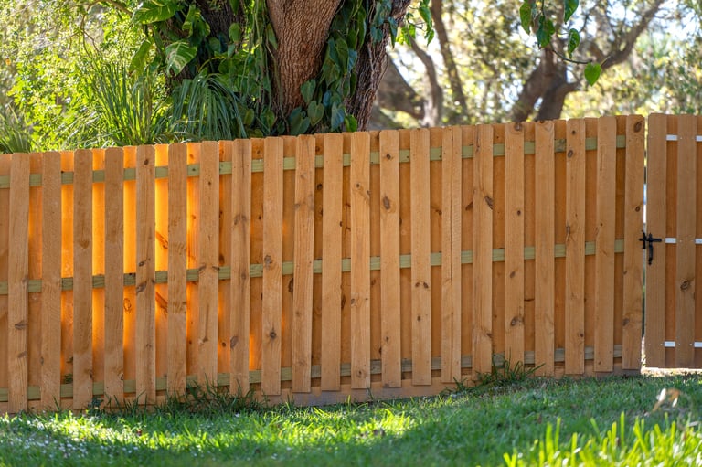 Beautiful wooden garden fence panels providing privacy and protection in residential backyard, professional fence installation by TJ's Tree and Garden