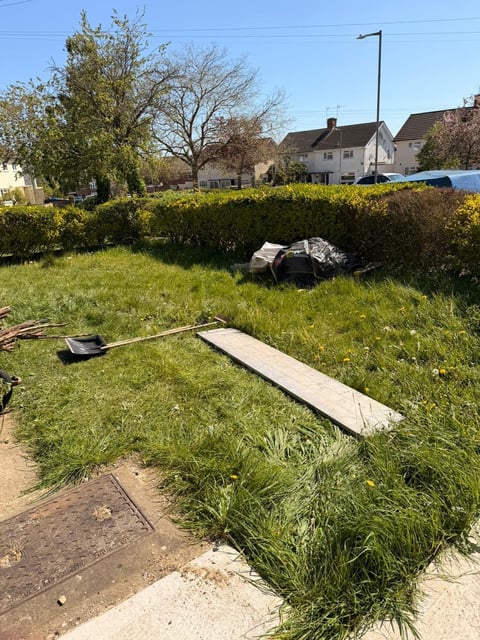 Residential garden requiring clearance work — overgrown garden with scattered tools and concrete slabs before transformation by TJ's Tree and Garden Services